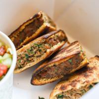 Arayes · Lebanese beef stuffed pitas served with tzatziki for dipping and choice of side (think of th...