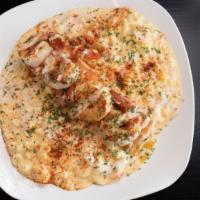 Tenille'S Seafood Mac N Cheese · Lump crab, lobster and shrimp baked in 5 cheese mac. Topped with jumbo garlic butter pan sea...