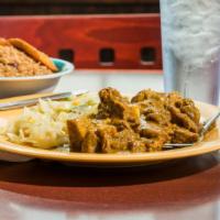 Curry Goat · Entrees are served with choice of rice and fried plantains. (without substitution)