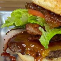 Greenyard Burger · Juicy beef burger, bacon, onion jam, lettuce, tomato, Cheddar cheese, BBQ sauce and mayo on ...