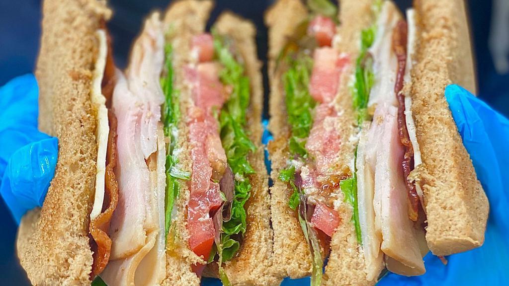 Turkey Club · Sliced turkey, bacon, provolone cheese, spring mix and our house made onion jam on sliced bread.