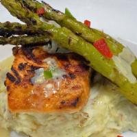 Grilled Salmon · Fresh salmon grilled with garlic herb lemon butter. Served with two sides.