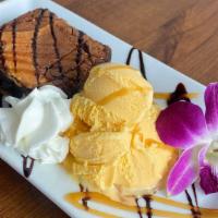 Brownie · Warm brownie served with a scoop of french vanilla ice cream and drizzled with chocolate and...
