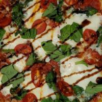 Margherita · Our tomato pizza sauce, fresh basil, tomatoes, fresh mozzarella.
