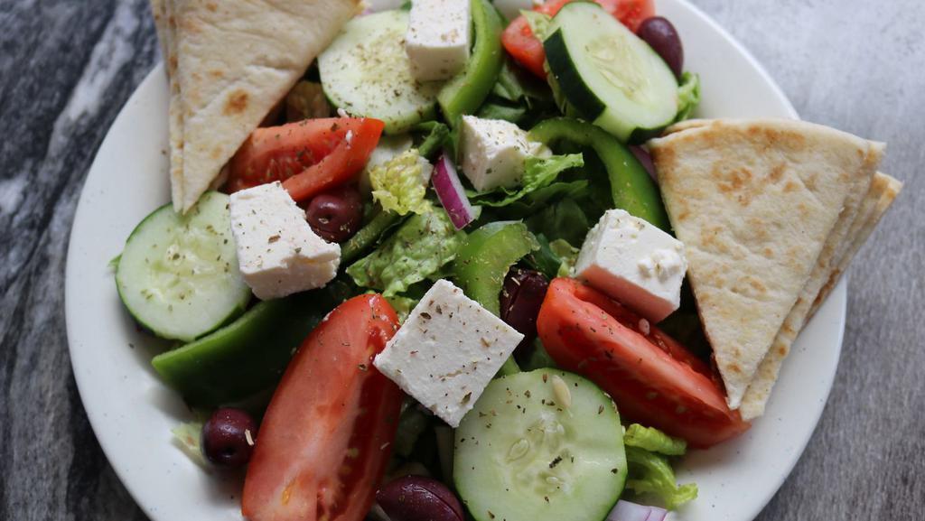 Traditional Greek Salata · Romaine lettuce, tomatoes, red onions, cucumbers, green peppers, kalamata olives and feta tossed in our signature Greek vinaigrette and dried oregano.