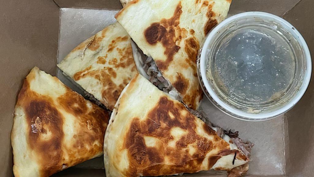 French Dip Quesadilla · Flour tortilla, braised beef, mozzarella, Swiss, au jus.
Served with fries, salad or chips.