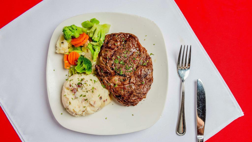 Ribeye Steak · 12OZ Ribeye With Garlic Butter Served With Mashed Potatoes & Mixed Vegetables.