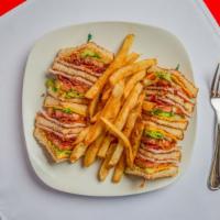 Triple Decker Club · Smoked turkey breast, bacon, tomato, lettuce, and mayo on wheat toast. Served with fries.