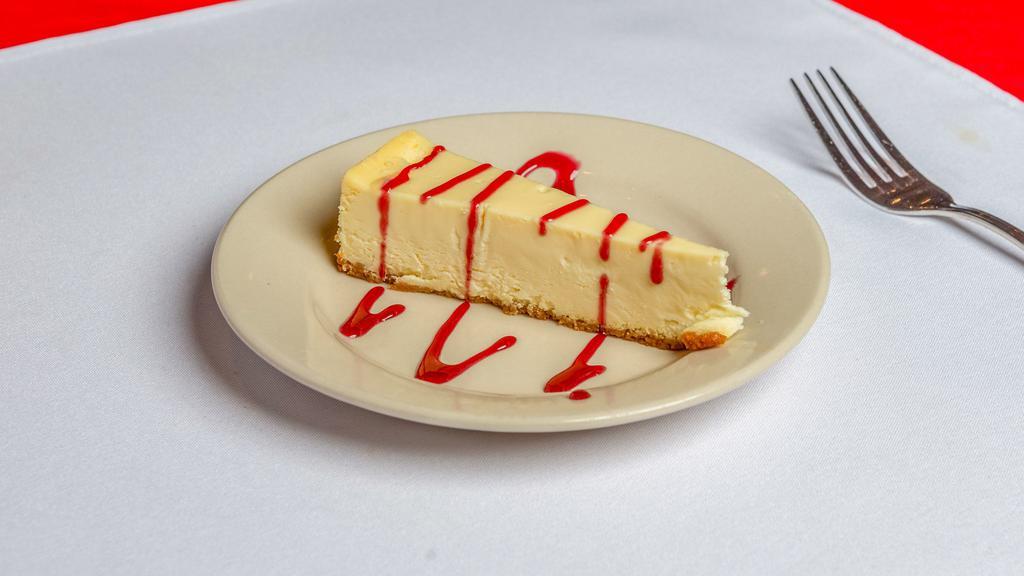 Cheesecake · New York Style Cheesecake Toped With Raspberry Sauce.