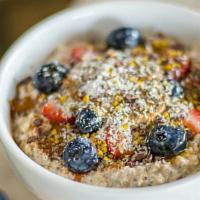 Overnight Oats · Just oats, almond milk, chia seeds, topped with honey, cinnamon, strawberries, blueberries, ...