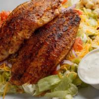 Blackened Catfish Salad · Fresh iceberg lettuce, tomatoes, onions, and shredded cheese. Topped with two sizzling black...