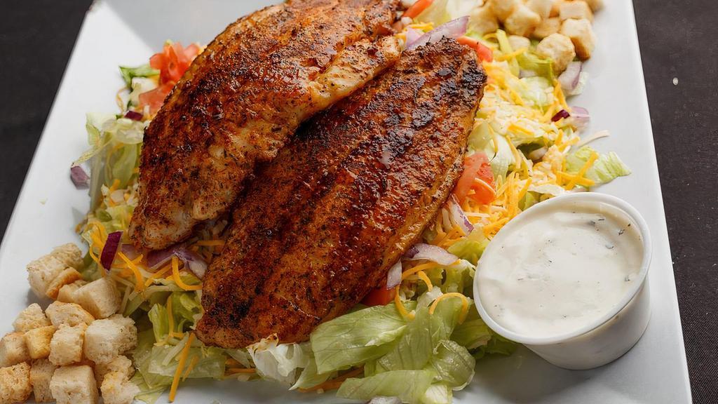 Blackened Catfish Salad · Fresh iceberg lettuce, tomatoes, onions, and shredded cheese. Topped with two sizzling blackened catfish filets and your choice of dressing.