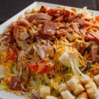 Chef Salad · Fresh iceberg lettuce, tomatoes, onions, and shredded cheese. Topped with sliced barn, diced...