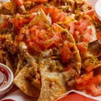 The Classic Nachos · Freshly fried corn tortilla chips with your choice of meat piled high with toppings. Topped ...