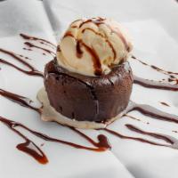 Lava Fudge Cake · chocolate cake with a creamy, dark, and dense chocolate center. Served with vanilla ice cream.