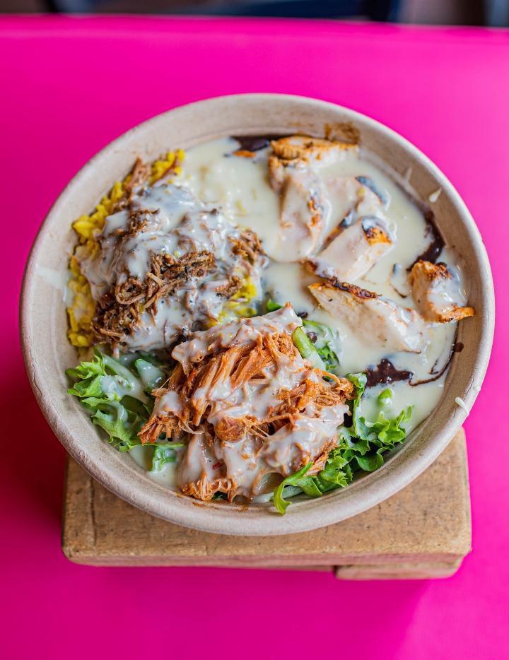 Favian'S Bowl · Explosion of flavors! Three proteins: carnitas, chicken tinga and grilled chicken over a bed of rice and beans mix greens and topped with queso dip.