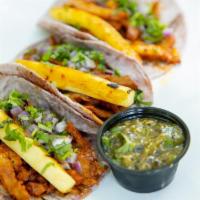 Tacos Al Pastor (2) · Adobo-marinated pork shoulder / grilled pineapple / cilantro / onions. Two blue corn tortill...