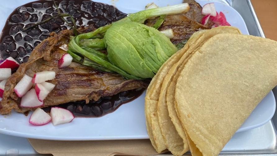 Carne Asada Plate · Marinated steak, grilled scallions, lime rice, refried beans, radishes and sliced avocado.