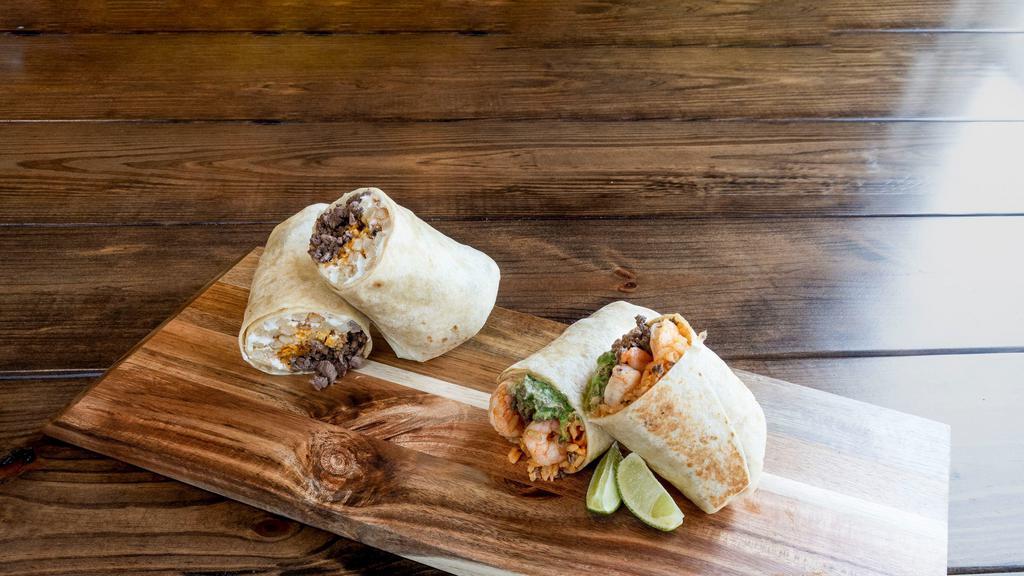 Surf & Turf Burrito · Grilled steak and shrimp, with our chipotle cream sauce, guacamole and rice.