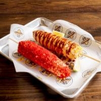 Flamin' Hot Cheetos Elote · Corn cobb covered in mayo, crushed hot cheetos and butter.