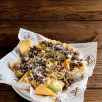 Bandido Super Nachos · Homemade chips topped with your choice of grilled steak or chicken, refried beans, sour crea...