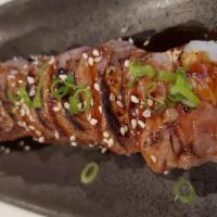 Cow Boy Roll · Soy wrapped: crawfish inside, marinated select beef (medium-rare), green onions, sesame seed...