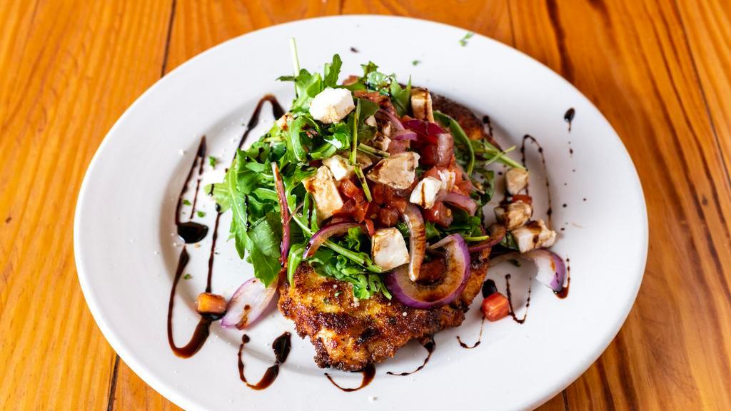 Milanese · Lightly breaded and pan fried topped with fresh mozzarella, red onion, vine ripe tomato, arugula, olive oil, and balsamic vinegar.