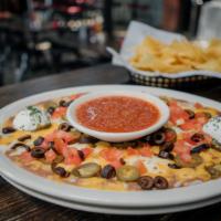Nachos · fresh tortilla chips, refried beans, black olives, diced tomatoes, cheddar cheese, mozzarell...