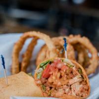 Spicy Buffalo Chicken Wrap · fried chicken strips tossed in buffalo sauce, bleu cheese crumbles, banana peppers, greens, ...