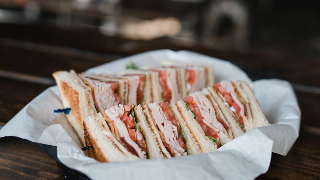 Club Sandwich · Fresh oven-roasted turkey and crispy bacon served triple-decker on toasted bread with lettuce, tomatoes, mozzarella cheese and mayo.