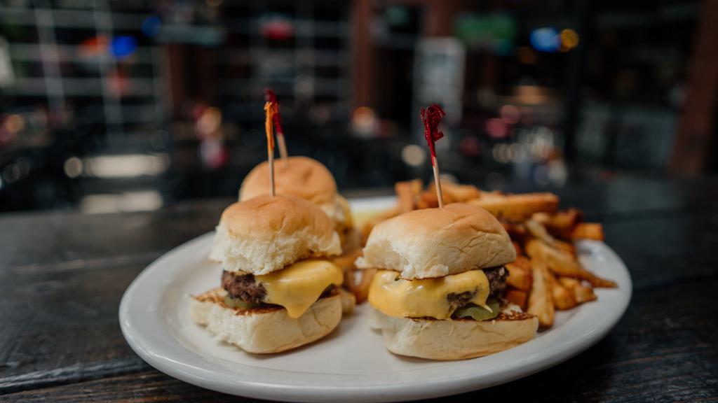 Cheeseburger Sliders · 3 juicy burgers topped with American cheese and pickles on Kings Hawaiian Rolls. Served with your choice of side.