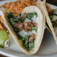 Street Tacos · Corn tortillas filled with seasoned steak, onions, cilantro and topped with fresh roasted to...