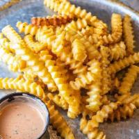 **Crinkle Cut Fries · Crispy Yukon Gold crinkle cut fries, seasoned with our house fry seasoning blend for loads o...