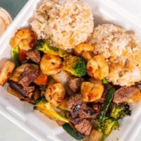 Hibachi Steak & Shrimp · Serve with Broccoli, Carrot, Zucchini & Onion 
Fried Rice  And one White Sauce .