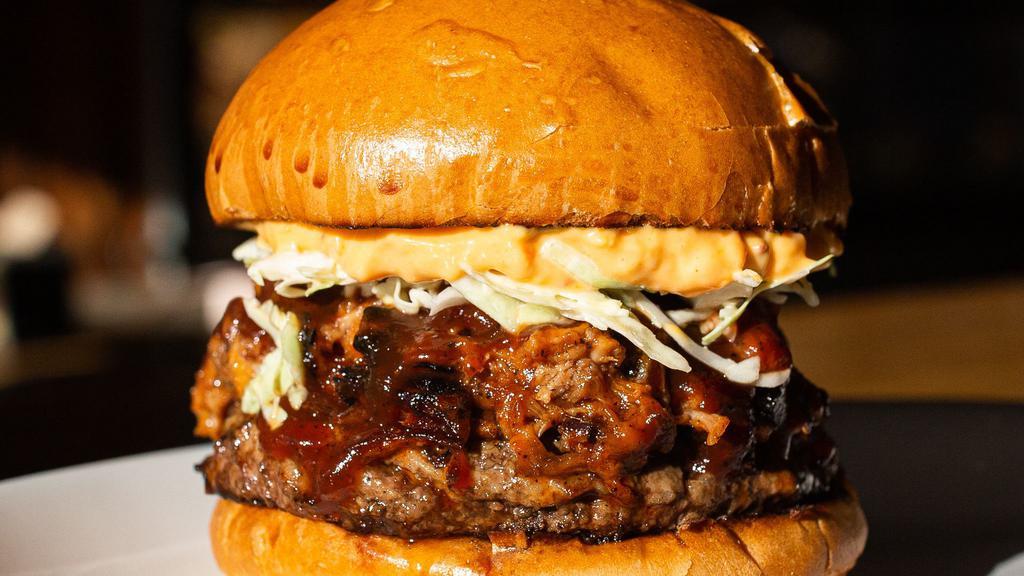 Tar Heel Burger · 8oz certified Angus beef patty, smoked pulled pork, AD's BBQ sauce, pimento cheese, slaw on a brioche bun