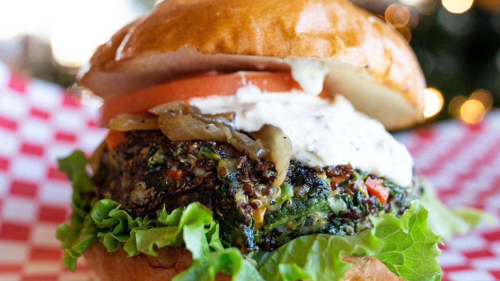 Spinach Quinoa Burger · House made spinach and quinoa patty with parmesan cheese, roasted red pepper, garlic and carrot patty, lettuce, tomato, sautéed onion, feta and dill cheese spread, and  brioche bun.