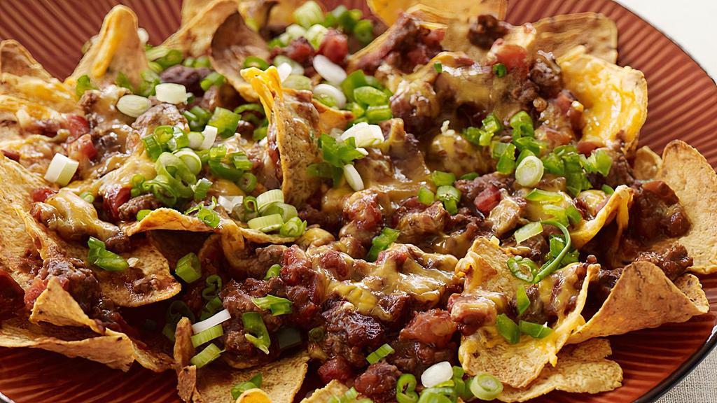 Beef Nachos · Served with Jalapeños, lettuce, tomatoes, sour cream and salsa.