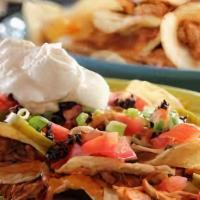 Chicken Nachos · Served with Jalapeños, lettuce, tomatoes, sour cream and salsa.
