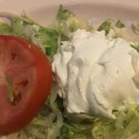 Taco Salad · Our choice of seasoned ground beef or shredded chicken. Prepared with onion, tomatoes, and b...