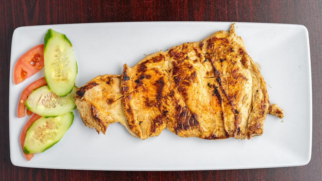 Pechuga A La Plancha · Grilled chicken breast, served with french fries, rice, and beans.
