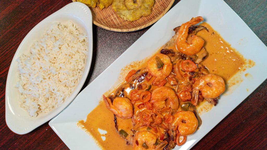 Pechuga A La Plancha Con Camarones · Grilled chicken breast and shrimp topped with mushrooms cream served with rice, beans, and green plantains.