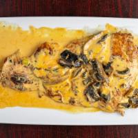 Pechuga Con Champinones · Chicken breast topped with mushrooms cream served with rice and sweet plantains.