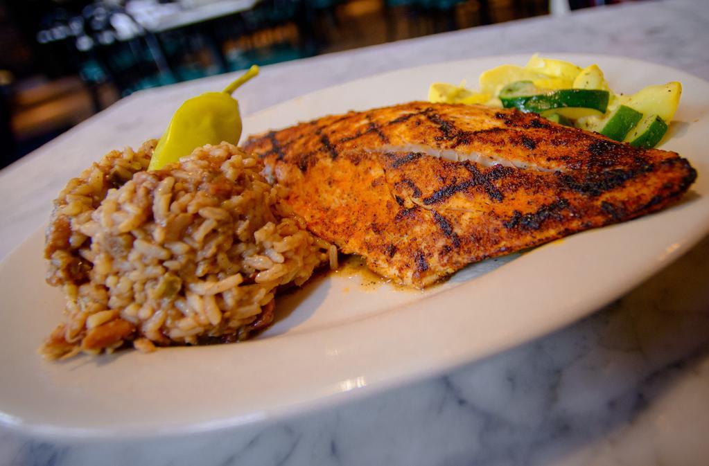 Blackened Redfish · Fresh Louisiana catch blackened with Cajun seasonings and served with steamed vegetables and jambalaya.