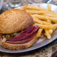 Muffuletta · A New Orleans original! Sesame-crusted Italian bun layered with our own unique olive salad, ...