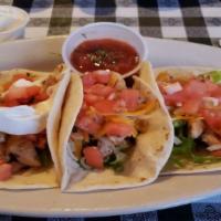 Tacos (Gf) · 3 corn (GF) or flour tortillas filled with lettuce,
tomatoes and cheddar jack cheese. Salsa ...