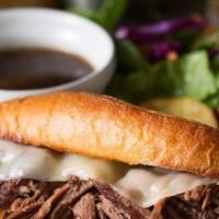 French Dip · Shaved Rib Eye, Sautéed Onions, Provolone cheese, served with Fries, Au Jus, Coleslaw and Pi...