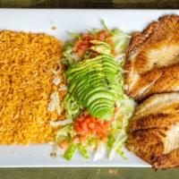 Tilapia Fish · Two pieces of tilapia served with rice, lettuce, avocado, and tomato.