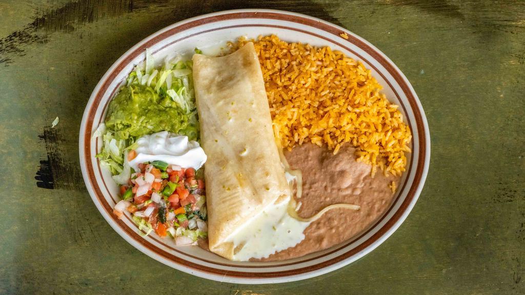 Chimichanga · Stuffed flour tortillas with your choice of beef or chicken, deep-fried to a golden brown and topped with cheese sauce. Served with lettuce, sour cream, guacamole, pico de gallo, rice, and beans. Popular.