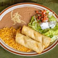 Taquitos Mexicanos · Four beef or chicken rolled corn tortillas served with lettuce, guacamole, sour cream, and p...