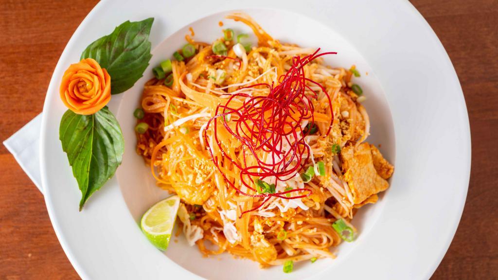Pad Thai · Traditional stir fried rice noodle dish with egg, bean sprout garnished with fresh ground peanuts & lime.